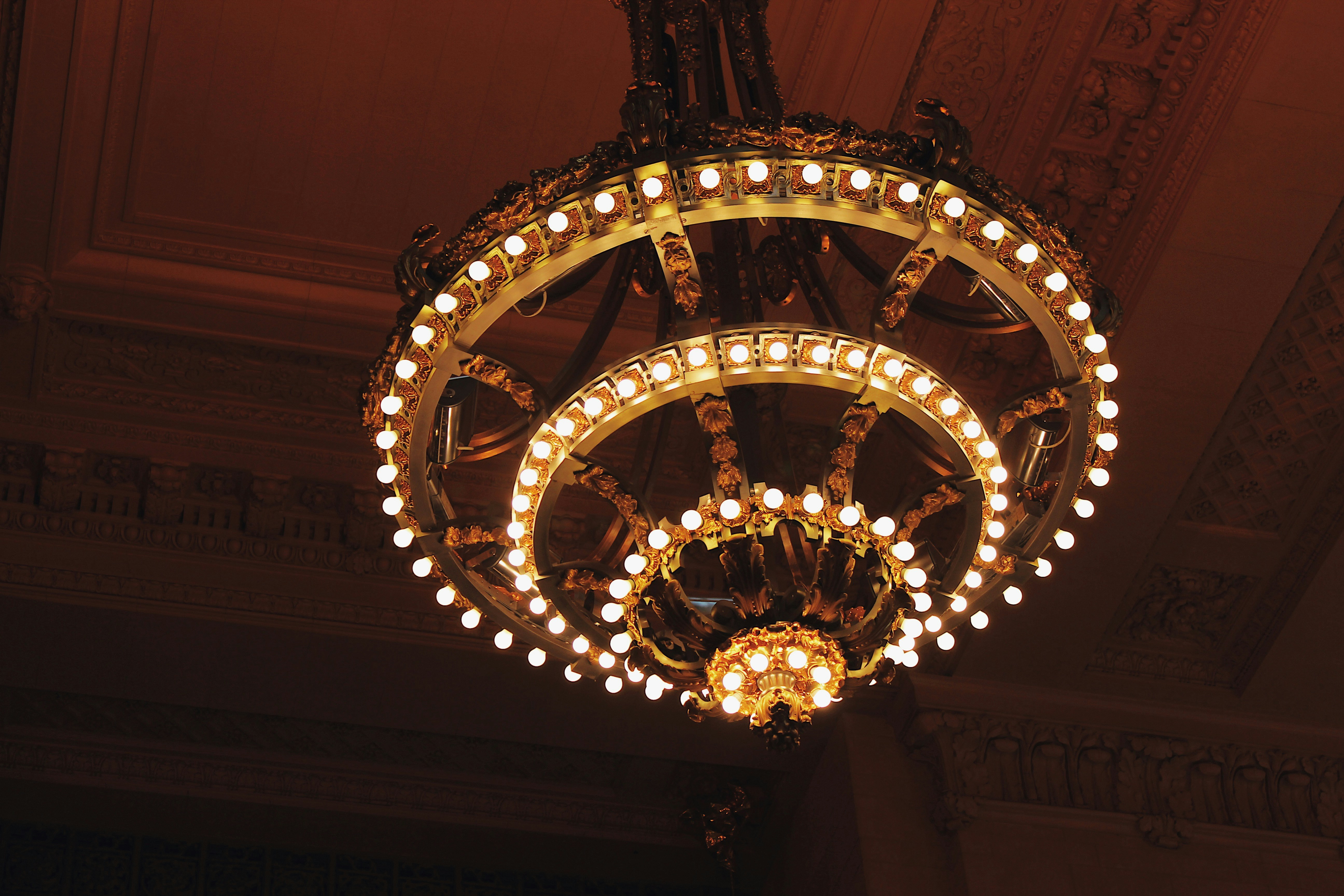 Ornate multi-tiered gold chandelier installation