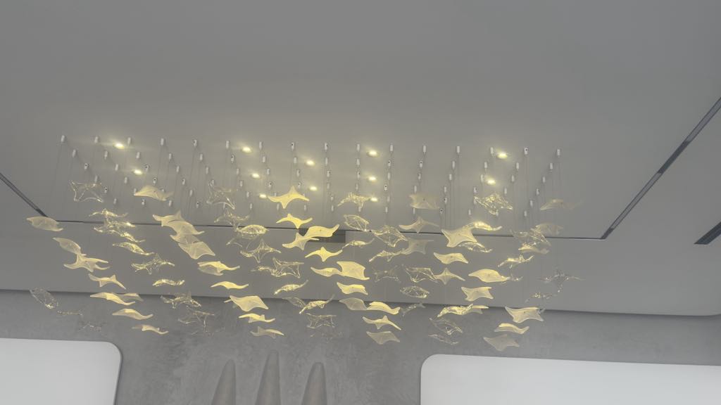 Linear chandelier with suspended glass leaves